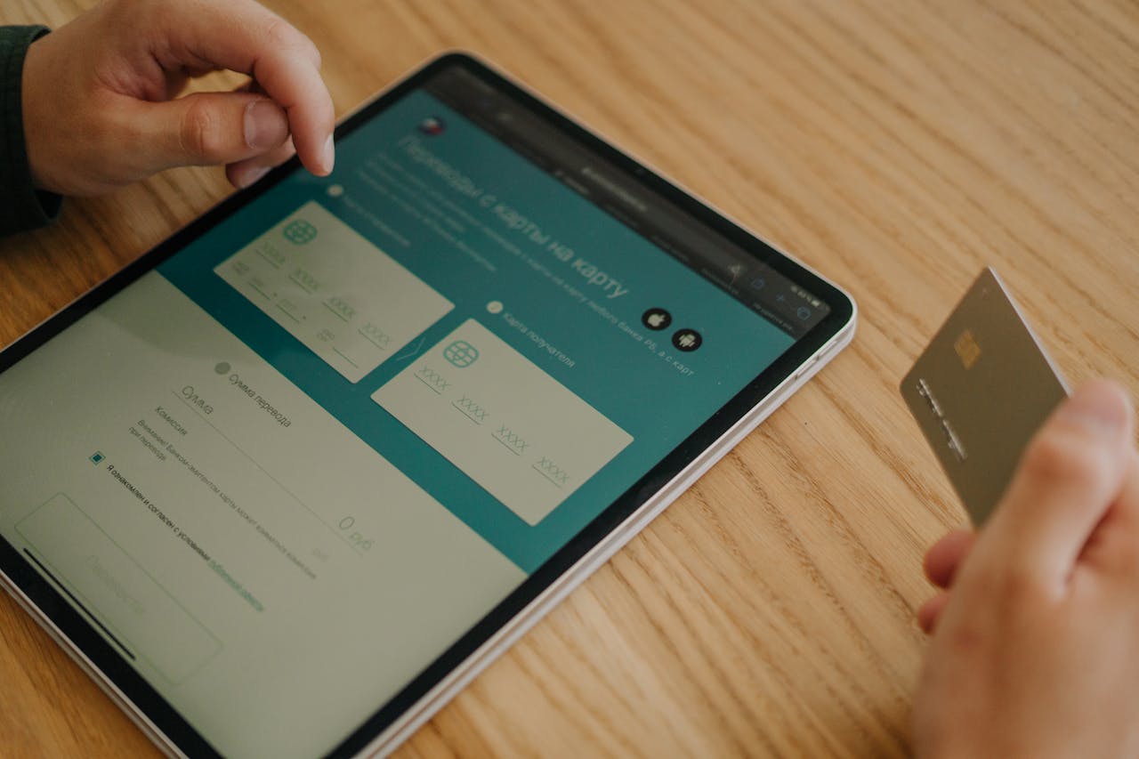 Mastering the First Impression: Your intriguing post title goes here Hands making an online purchase using a tablet and credit card on a wooden table.